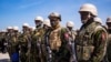 Polisi Kenya berdiri di landasan Bandara Internasional Toussaint Louverture setelah mendarat di Port-au-Prince, Haiti, Selasa 25 Juni 2024.