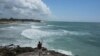 A man takes a video from the rocky shore of Mirador beach ahead of Hurricane Beryl's expected arrival, in Tulum, Mexico, July 4, 2024.