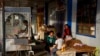 FILE - A Uyghur woman works while children play in Hotan, in western China's Xinjiang region, Sept 20, 2018. China faced international criticism about its human rights record, mainly on its treatment of Uyghurs, Thursday at a United Nations Human Rights Council session in Geneva.