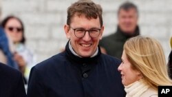 FILE - Minister of Climate Kristen Michal, left, stands as Estonian Prime Minister Kaja Kallas walks by before welcoming Sweden's royalty in Tallinn, Estonia, May 2, 2023.