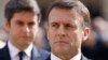 FILE - French President Emmanuel Macron and French Prime Minister Gabriel Attal, background, attend a ceremony in Paris, March 20, 2024. Following a snap legislative election, Macron has lost his parliamentary majority.