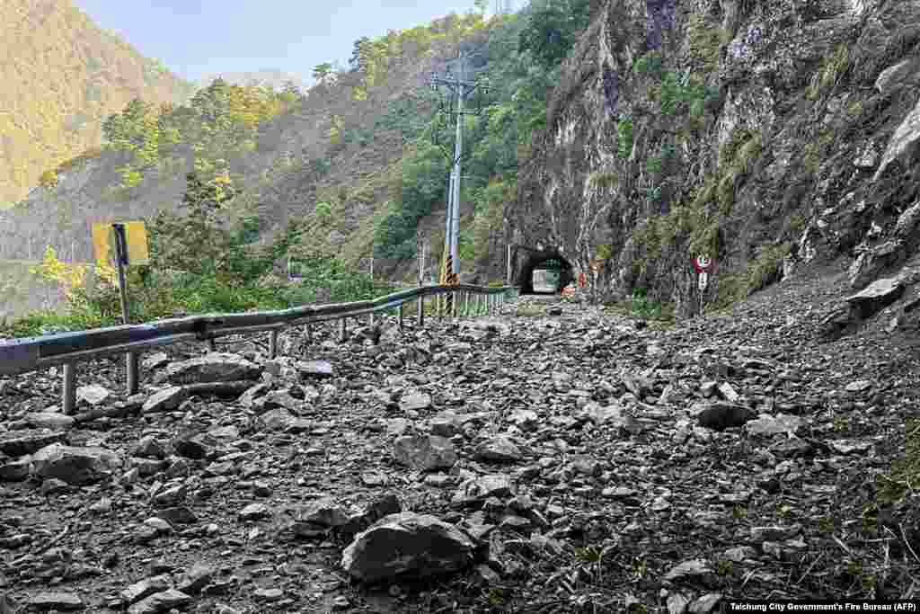 This handout photo from the Taichung City Government's Fire Bureau taken and released on April 3, 2024 shows rocks along part of the road on a section of a highway in Taichung, after a major earthquake hit Taiwan's east.