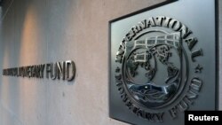 FILE - The International Monetary Fund logo is posted the headquarters building in Washington, September 4, 2018. 
