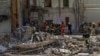 Workers clear the rubble at the site of Okhmatdyt children's hospital in Kyiv, Ukraine, July 9, 2024, a day after it was hit by a Russian missile.