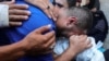A Palestinian father grieves over the body of his son who was killed in an Israeli strike, amid the Israel-Hamas conflict, at Al-Aqsa Martyrs Hospital in Deir Al-Balah in the central Gaza Strip, July 9, 2024.