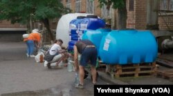 Stanovnici pune balone i flaše vodom, nakon što su im slavine gotovo u potpunosti presušile, u Nikopolju, Ukrajina, 26. juna 2023.