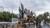 Taliban fighters celebrate one year since they seized the Afghan capital, Kabul, in front of the U.S. Embassy in Kabul, Afghanistan, Aug. 15, 2022. 