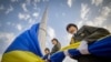 In this photo provided by the Ukrainian Presidential Press Office, honour guard soldiers prepare to rise the Ukrainian national flag during State Flag Day celebrations in Kyiv, Ukraine, Aug. 23, 2022.