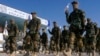 Taliban fighters march during a graduation ceremony after military training in Herat, Afghanistan, on Jan. 10, 2022. On Aug. 17, 2022, the Taliban said that their security forces killed a fugitive rebel commander in a shootout near the Iranian border.