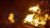 Facilities of a complex that prepares natural gas for transportation are pictured in a fire after night shelling, as Russia's attack on Ukraine continues, in the village of Hlazunivka in Kharkiv region, Ukraine, in this handout picture released March 13, 