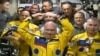 Ruski kosmonauti Oleg Atremiev (u sredini), Denis Matvev (desno) i Sergej Korsakov poziraju među drugim članovima ekspedicije na Međunarodnoj svemirskoj stanici ISS, 18. marta 2022.
