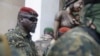 FILE - Guinea junta leader Mamady Doumbouya, leaves a meeting with an ECOWAS delegation in Conakry, Guinea, Sept. 10, 2021. Coup leaders on Saturday announced a ban on political protests in the country.