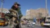 A Taliban fighter stands guard on a road after a blast during Friday prayers at Guzargah mosque, in Herat, Sept. 2, 2022.
