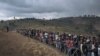 FILE - Displaced persons gather during a visit by the Congolese defense minister, not visible, to the internally displaced persons camp of Bijombo, South Kivu Province, eastern Democratic Republic of Congo, Oct. 10, 2020. 