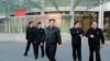 This undated picture released from North Korea's official Korean Central News Agency (KCNA) on March 10, 2022, shows North Korean leader Kim Jong Un, center, inspecting North Korea's National Aerospace Development Administration in Pyongyang.