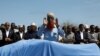 Relatives and Somali government officials pray near the slain body of Amina Mohamed Abdi, a vocal critic of the government, who was killed in a suicide explosion in Beledweyne, at the Adan Abdulle International Airport international in Mogadishu, Somalia,
