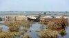 Homes are surrounded by floodwaters in Qambar Shahdadkot district of Sindh province, Pakistan, Sep. 2, 2022. Planes carrying supplies are surging across a humanitarian air bridge to flood-ravaged Pakistan as the death toll surged past 1,200, officials said Friday.