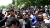 FILE - Former Pakistani Prime Minister Imran Khan, center, arrives to an anti-terrorism court in Islamabad, Pakistan, Sept. 1, 2022.