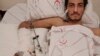 Syrian Ejnad Akkad, a fighter for the Syrian opposition Free Syrian Army, who was wounded by a mine planted by the Islamic State group near the border with Turkey, lays on his bed at a hospital in Kilis, Turkey, Feb. 9, 2016.