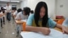 FILE - Junior high students study in a small cram school in hopes of success on their high school entrance exams, in Taipei, Taiwan.