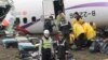 Emergency personnel sort through luggage recovered at the site of a commercial plane crash in Taipei, Taiwan, Feb. 5, 2015. 