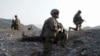 Staff Sgt. Joshua White, center, Command Sgt. Maj. John Troxell, left, and Brigade Sgt. Maj. Mike Boom, right, observe a joint patrol of U.S. Army and Afghan National Army soldiers and Afghan police in Paktika province, Afghanistan, on Oct. 3, 2011.