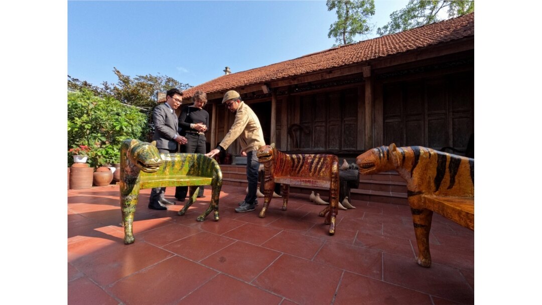 Nguyen Tan Phat shows his Tiger carving works to the customers ahead of the New Lunar New year in Hanoi, Vietnam January 18, 2022. (REUTERS/Stringer)