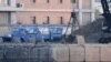 This general view shows emergency workers among damaged vehicles in a open parking area of northern Athens on July 26, 2018, after a flash flood struck the Greek capital.