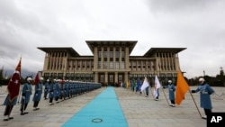 Military honor guards stand ready outside the new presidential palace complex in Ankara, Turkey, Dec. 1, 2014. 