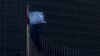 FILE - A European Union flag flutters outside EU Commission headquarters in Brussels, Belgium, Jan. 12, 2016.