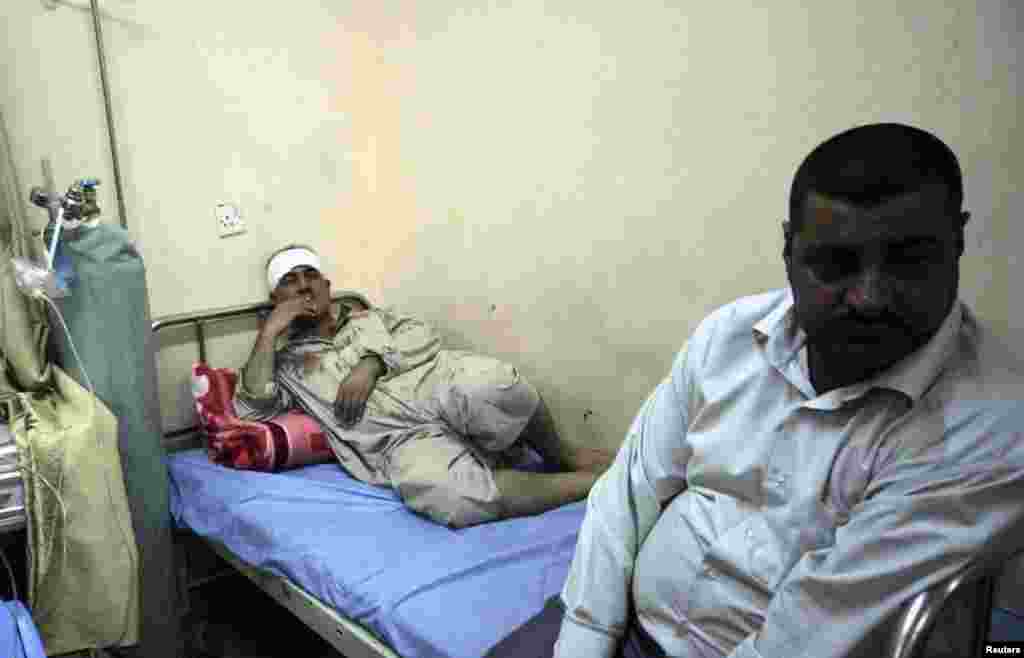 A man wounded in a bomb attack lies at a hospital in Karbala, Iraq, June 13, 2012.