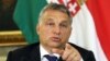FILE - Hungarian Prime Minister Viktor Orban, shown at a September press conference, has become a divisive figure throughout Europe. 