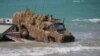 FILE - An Australian troop transporter wades onto Langham beach during military exercises in Queensland, northeast Australia, July 13, 2017.