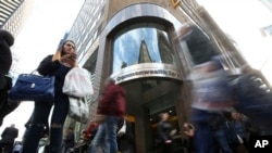 People walk past a Commonwealth Bank branch in Sydney, June 4, 2018. 