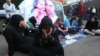 FILE - Families of Lebanese soldiers who were kidnapped by Islamic militants, block a main road during a protest after an al-Qaida-linked group in Syria says it has killed a kidnapped soldier Ali Bazzal, seen in poster with his daughter, in downtown Beirut, Lebanon on Dec. 6, 2014.
