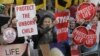 FILE - Protesters opposed to abortion hold placards outside a clinic in Belfast, Northern Ireland, Oct. 18, 2012. The New South Wales parliament in Australia is debating legislation to outlaw protests outside abortion clinics.