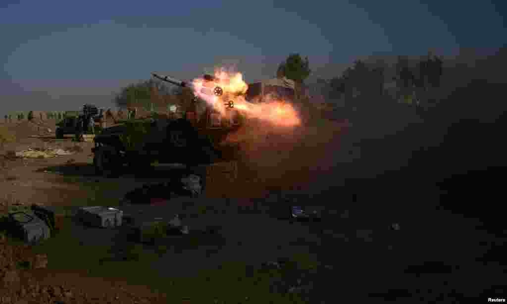 Popular Mobilization Forces (PMF) launch a rocket during clashes with Islamic State militants on the outskirts of the town of Hammam Al-Alil in south of Mosul, Iraq.