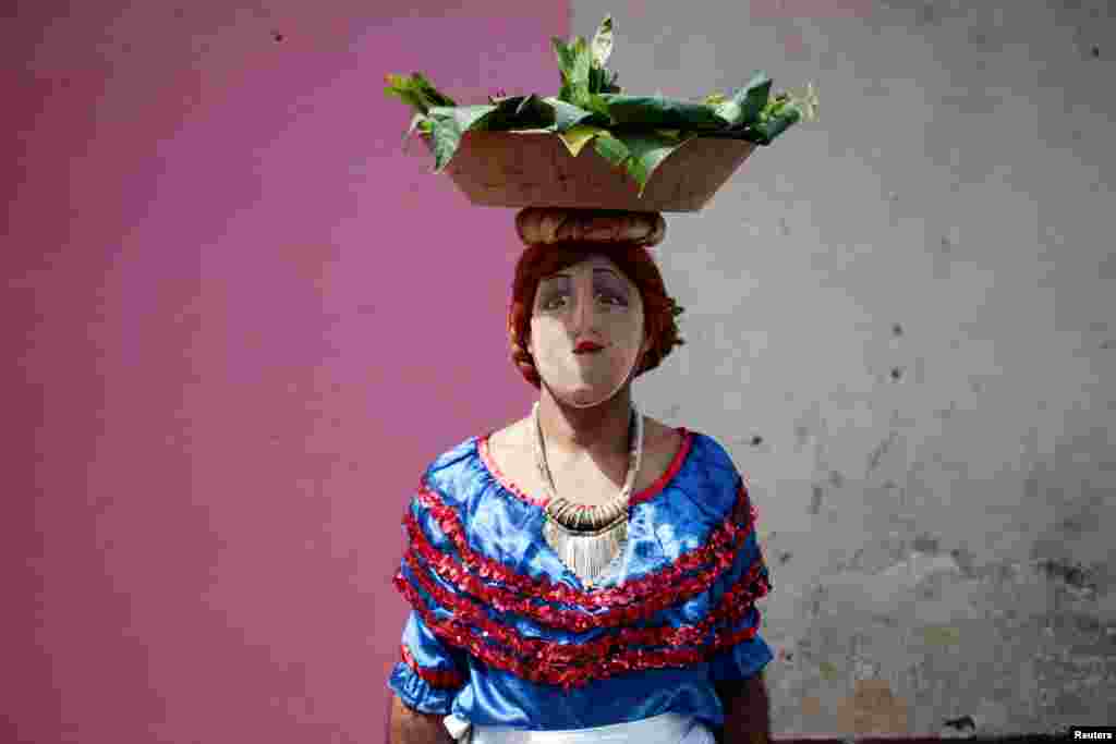 A man with a mask takes part in festivities in honor of patron saint San Jeronimo in Masaya city, Nicaragua, Nov. 20,2016.