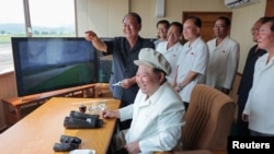 FILE PHOTO: North Korea's Kim Jong Un oversees drone test