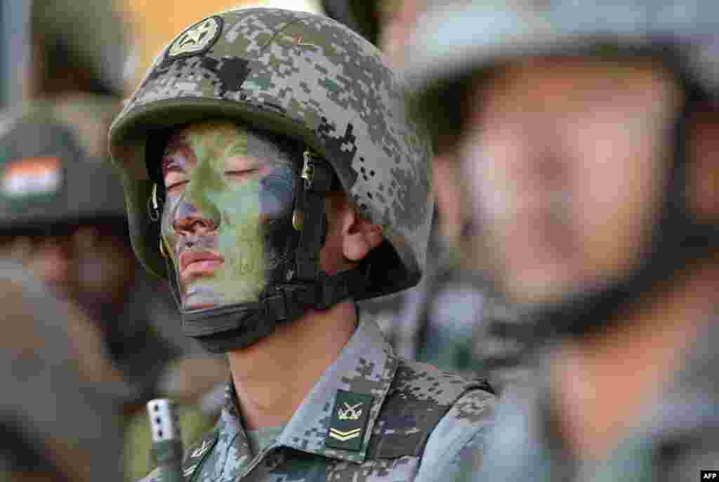 A People's Liberation Army (PLA) of China soldier looks on after participating in an anti-terror drill during the Sixth India-China Joint Training exercise "Hand in Hand 2016" at HQ 330 Infantry Brigade.