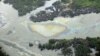 In this March 24, 2011 file photo, oil is seen on the creek's surface near an illegal oil refinery in Ogoniland, outside Port Harcourt, in Nigeria's Delta region (AP).