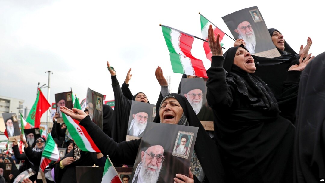 Demonstrators cry and pray as they hold up portraits of Supreme Leader Ayatollah Ali Khamenei at a pro-government rally denouncing last week’s violent protests over a fuel price hike, in Tehran, Iran, Monday, Nov. 25, 2019. (AP Photo/Ebrahim Noroozi)
