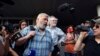 FILE - Dmitry Muratov, foreground, chief editor of Novaya Gazeta, and the Ekho Moskvy (Echo of Moscow) radio station's editor-in-chief, Alexei Venediktov, speak in Moscow, Russia, in June 2019.