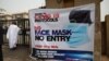 FILE - A trader looks on outside a market, which was closed by the country's COVID-19 taskforce over disregard to COVID-19 protection regulations, in Abuja, Nigeria, on Feb. 2, 2021.