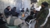 Rebel fighters of al-Jabha al-Shamiya (Levant Front) warm themselves around a fire near the justice palace in the old city of Aleppo, Syria, Jan. 28, 2016. 