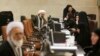 An Iranian cleric speaks with election staff while registering his candidacy for the February 26 Experts Assembly elections at the Interior Ministry in Tehran, Iran, Dec. 17, 2015.