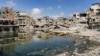 Sewage water from collapsed underground pipes covers an area by destroyed buildings in Khan Yunis in the southern Gaza Strip on July 8, 2024 amid the ongoing conflict in the Palestinian territory between Israel and Hamas.