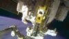 FILE - In this image taken from video provided by NASA, astronauts Rick Mastracchio, top, and Michael Hopkins work to repair an external cooling line on the International Space Station, Dec. 24, 2013.