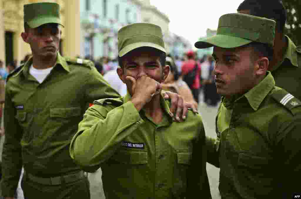Soldiers cry after the urn with the ashes of Cuban leader Fidel Castro was driven through Santa Clara during its four-day journey across the island for the burial in Santiago de Cuba.