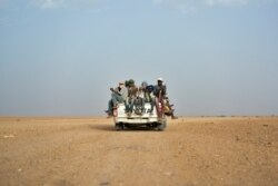 FILE - Nigeriens and third-country migrants head toward Libya from Agadez, Niger, June 4, 2018.